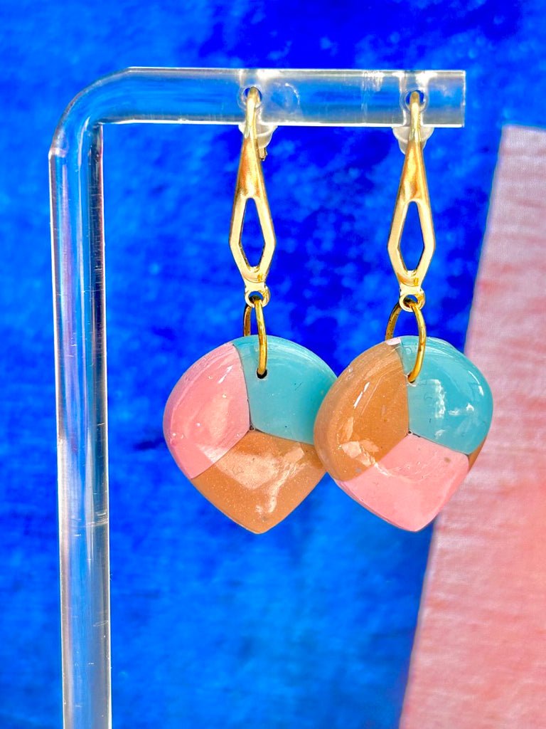 pastel geometric polymer clay earrings with blue, pink, and beige segments, hanging on gold-tone dangle hooks