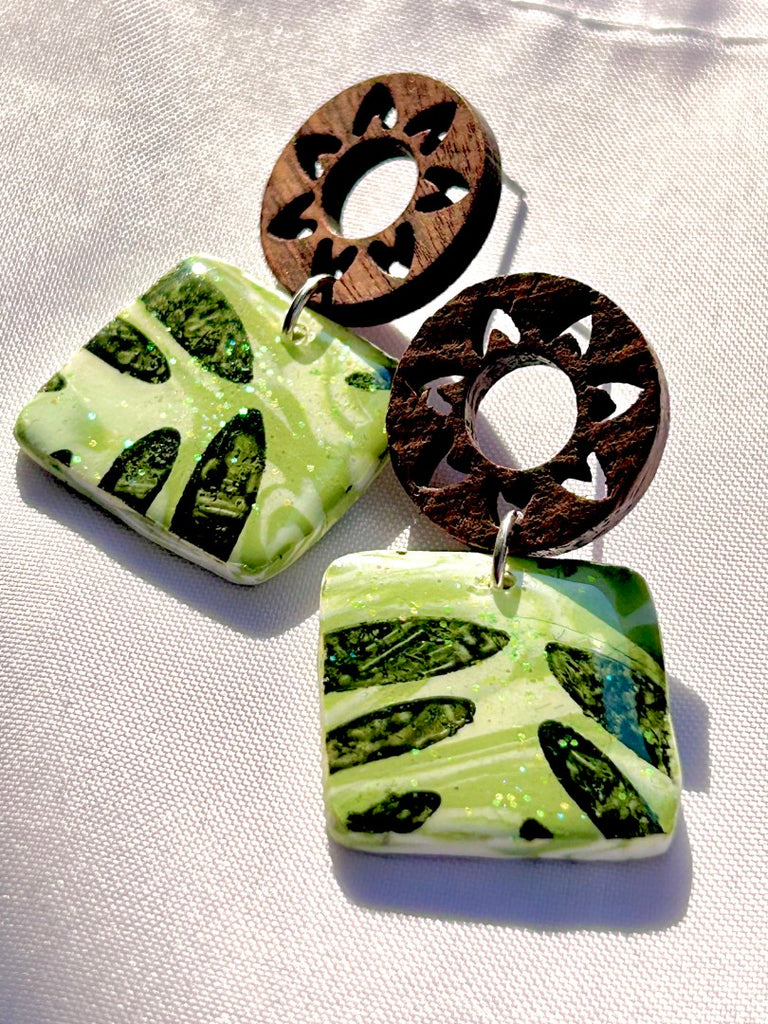 green leafy monstera polymer clay earrings with wooden sunburst studs