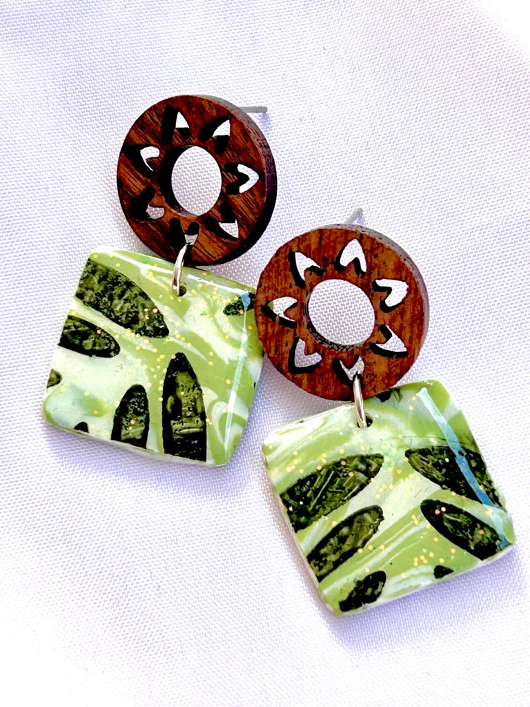 green leafy monstera polymer clay earrings with wooden sunburst studs