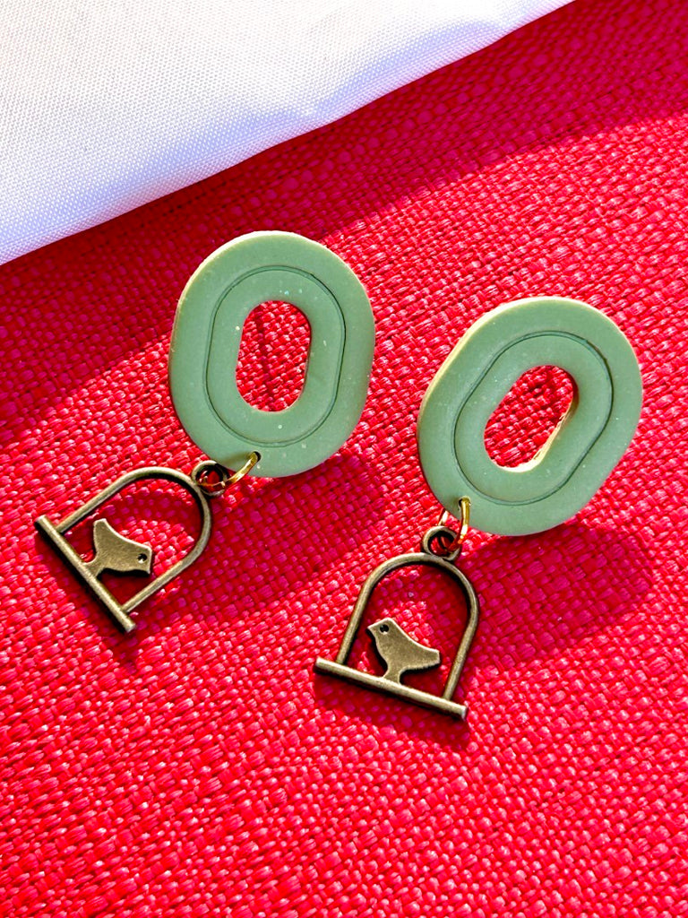 Sage green polymer clay earrings with bronze birdcage charm