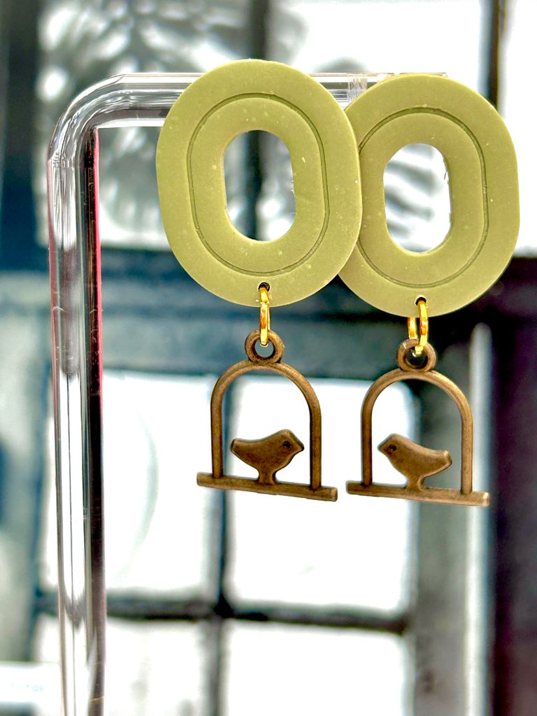 Sage green polymer clay earrings with bronze birdcage charm