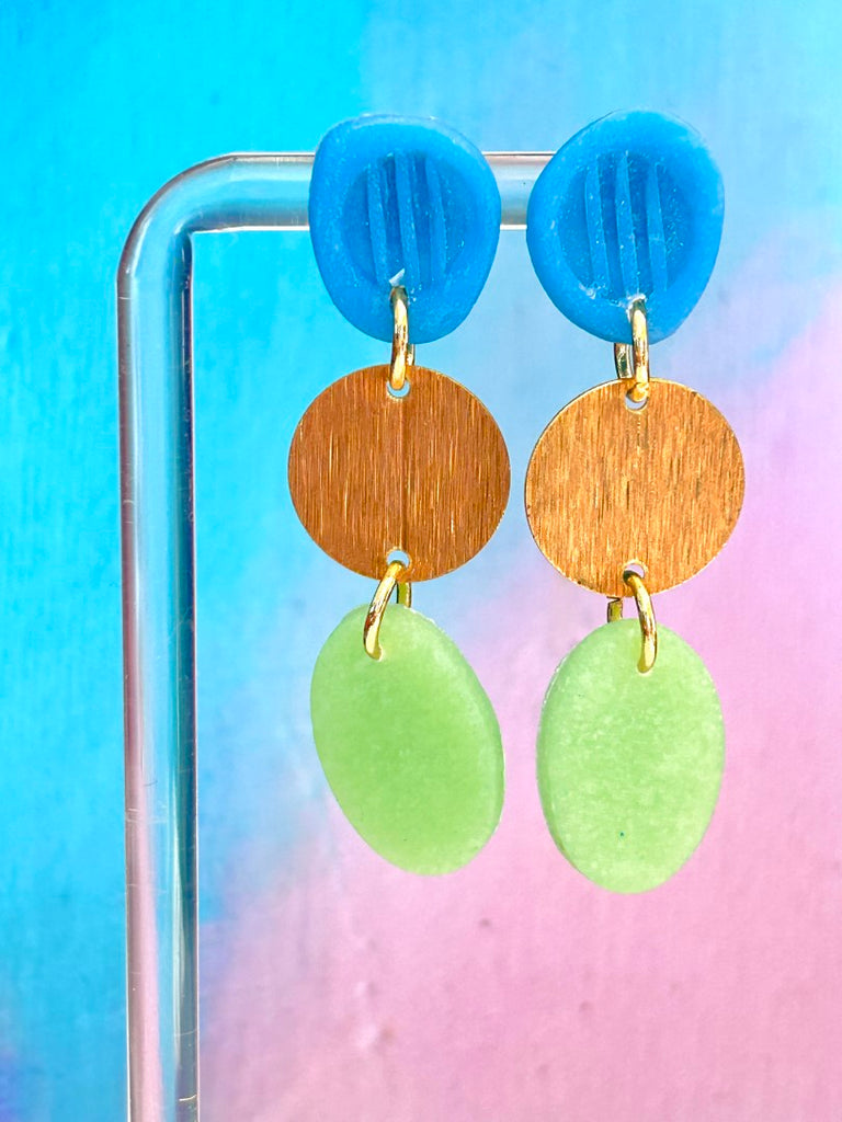 blue, gold, and green handmade polymer clay earrings with circular and oval shapes