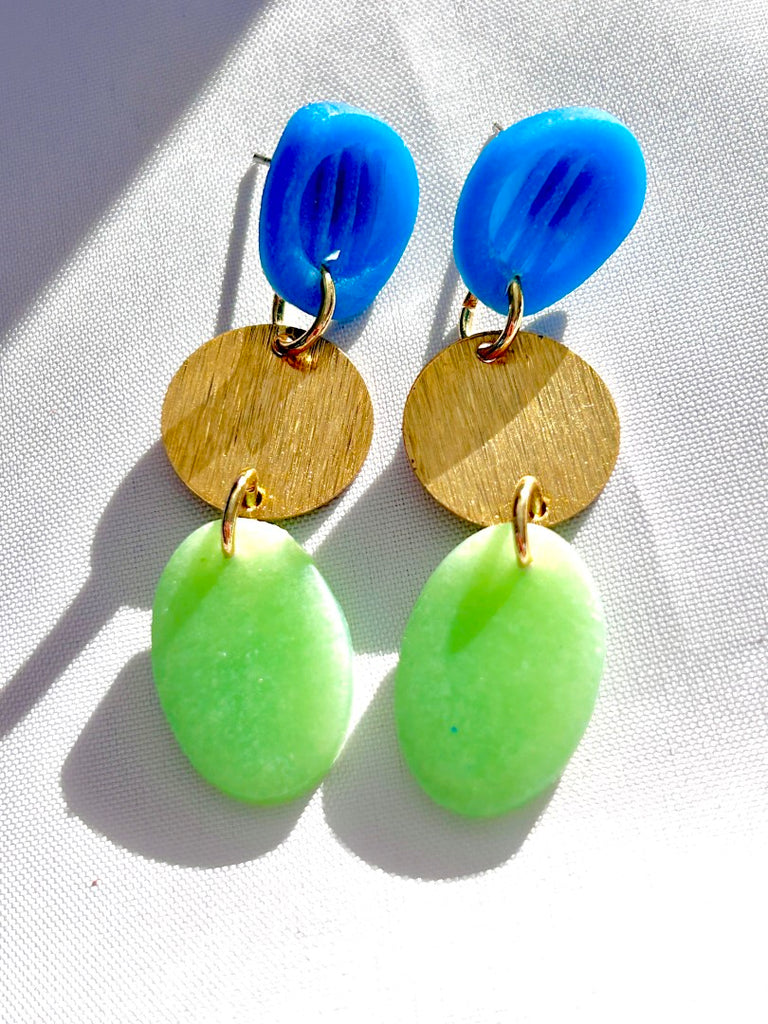 blue, gold, and green handmade polymer clay earrings with circular and oval shapes