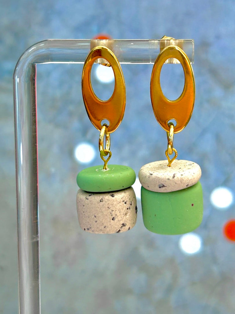 Asymmetrically stacked sage and coffee-speckled polymer clay earrings with golden oval studs